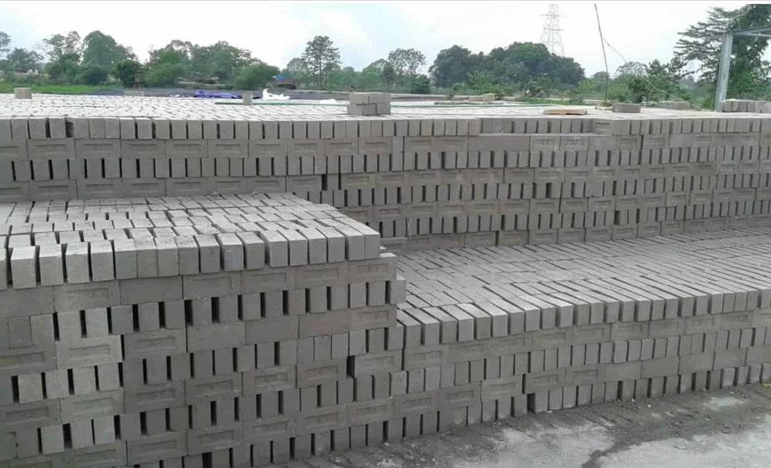 Stacks of finished fly ash bricks curing in the yard